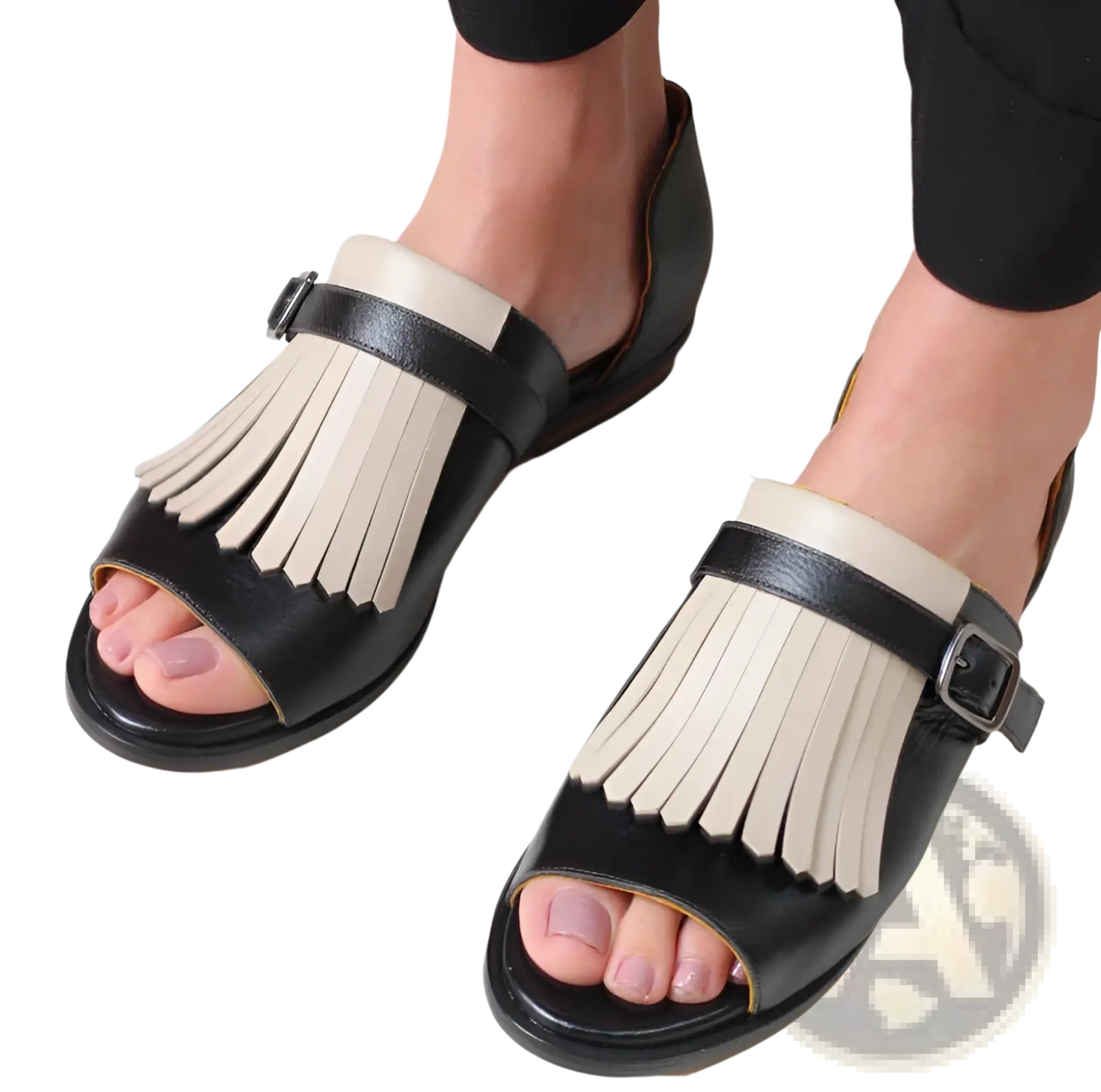 Women’s tassel leather beach sandals in black and cream featuring a fringed design and soft leather material