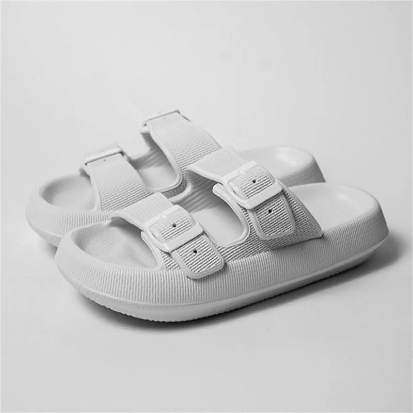 White women’s thick sole breathable eva massage sandals with two adjustable strap buckle closures made of rubber