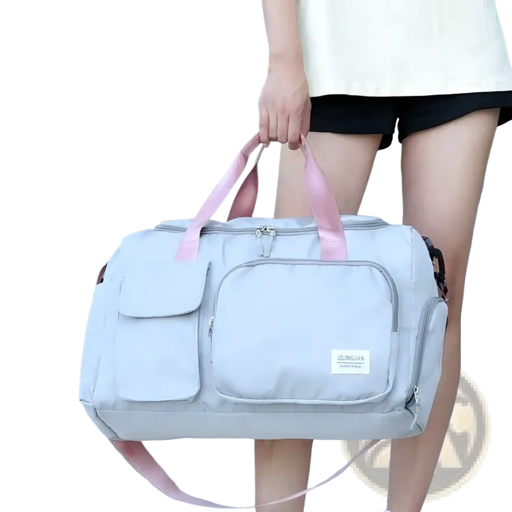 Light gray women’s travel duffle bag with pink handles and multiple pockets for gym and travel use