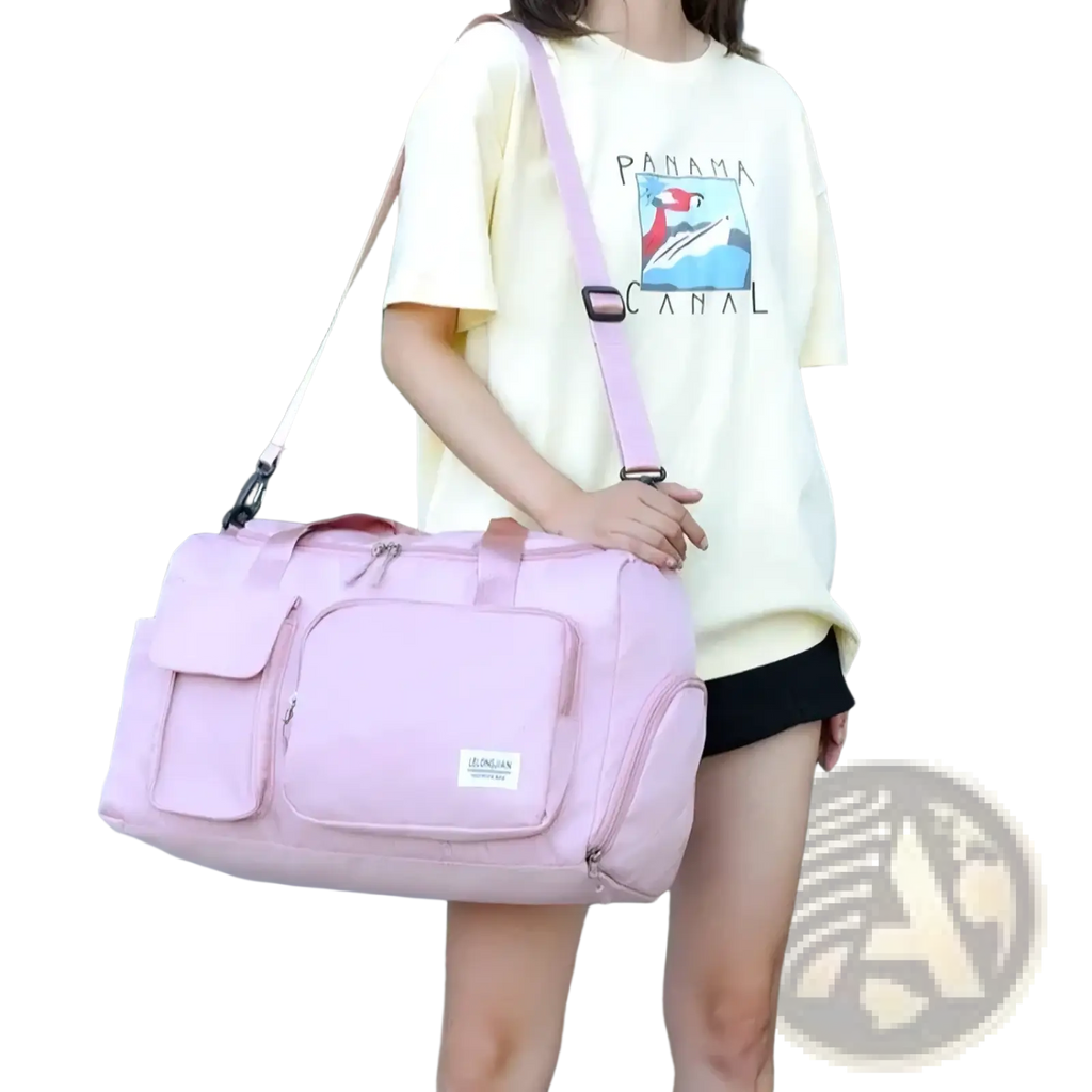 Pink canvas women’s travel duffle bag with multiple zippered compartments and matching shoulder strap for gym use