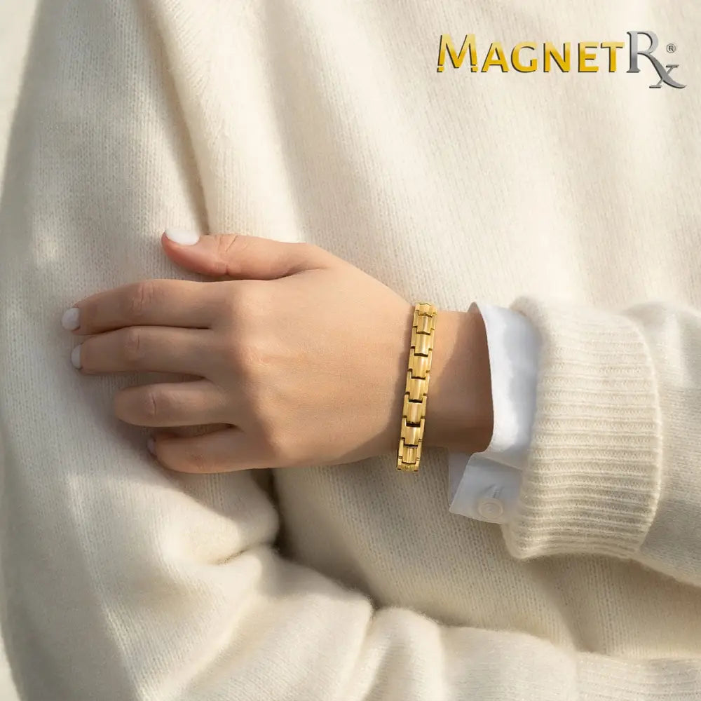 Women’s gold titanium magnetic therapy bracelet with 40 magnets and sleek interlocking link design worn on wrist