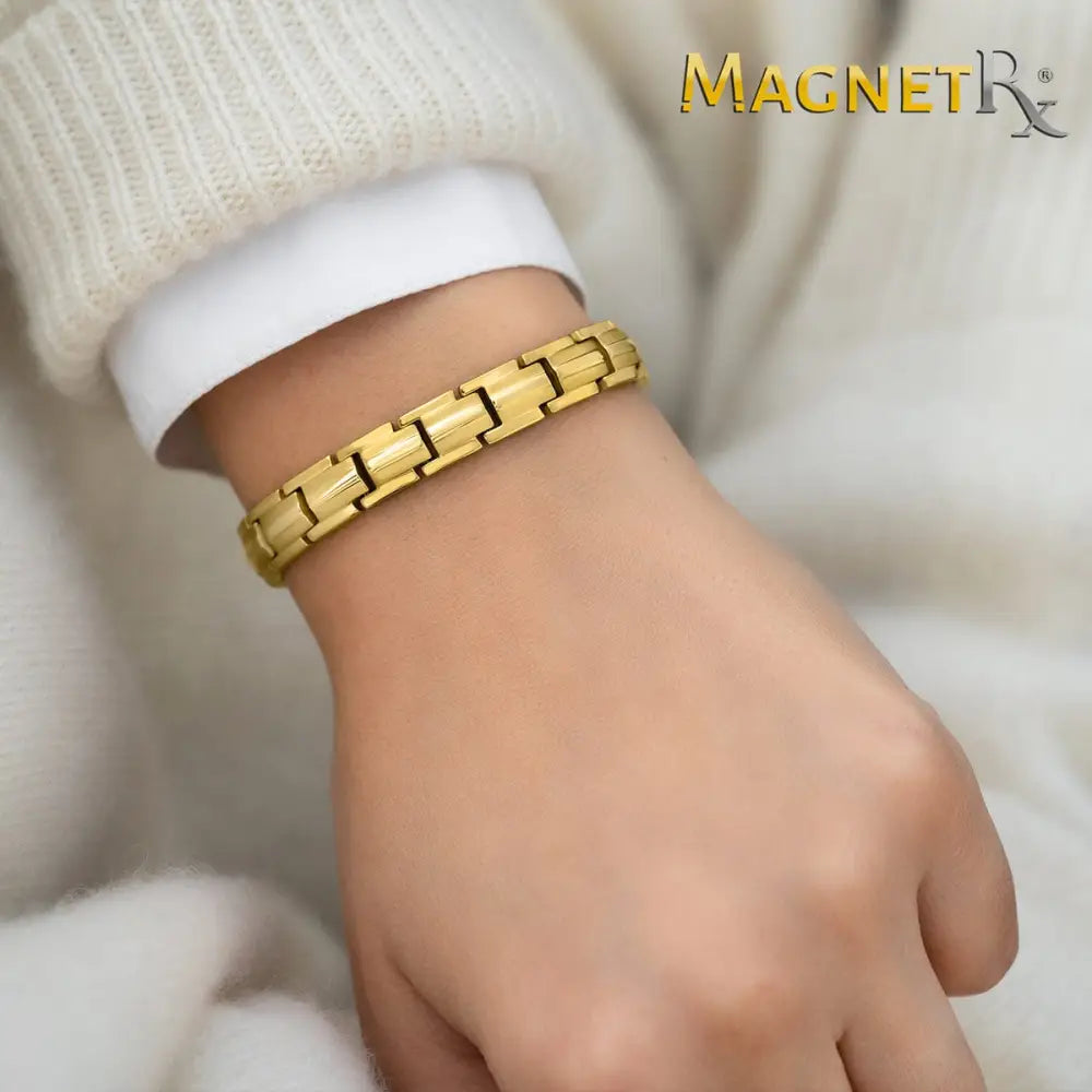 Woman’s gold titanium 40 magnet therapy bracelet with interlocking link design worn on a wrist