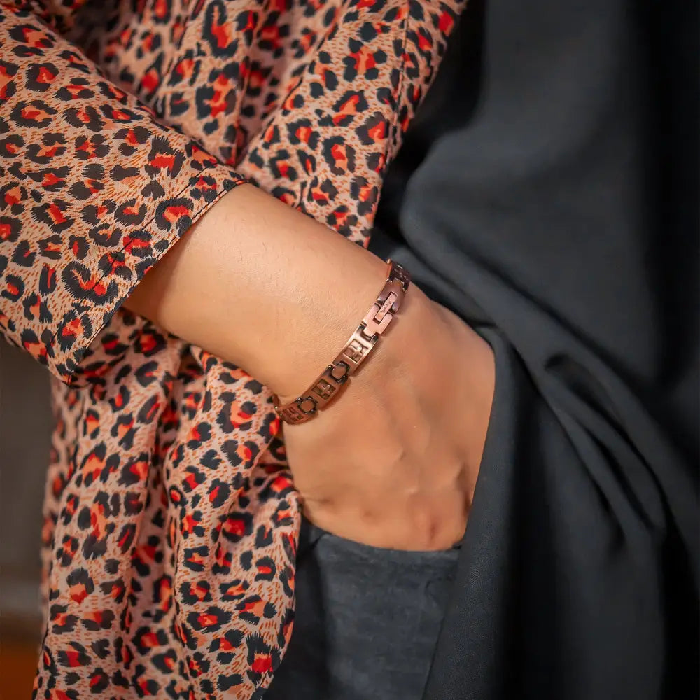 Rose gold cross engraved ultra strength copper magnetic bracelet with geometric links worn on a wrist
