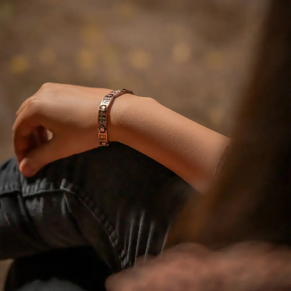 Rose gold cross engraved ultra strength copper magnetic bracelet with sleek interlocking chain worn on wrist