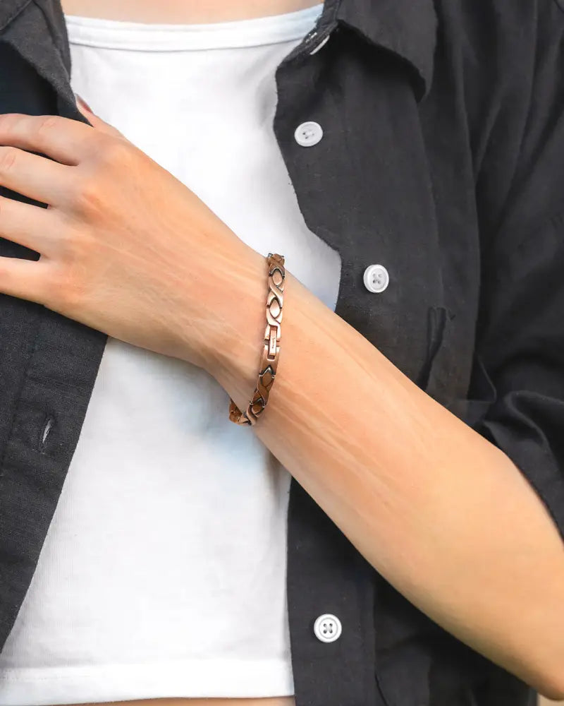 A bronze-colored rose gold braided pure copper magnetic therapy bracelet with a sleek interlocking chain design
