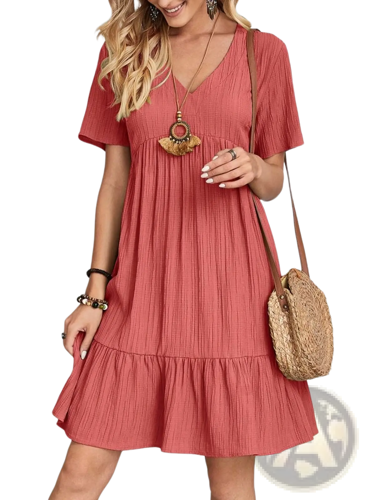 A soft coral-colored women’s v-neck tiered pleated summer dress with short sleeves and a ruffled hem
