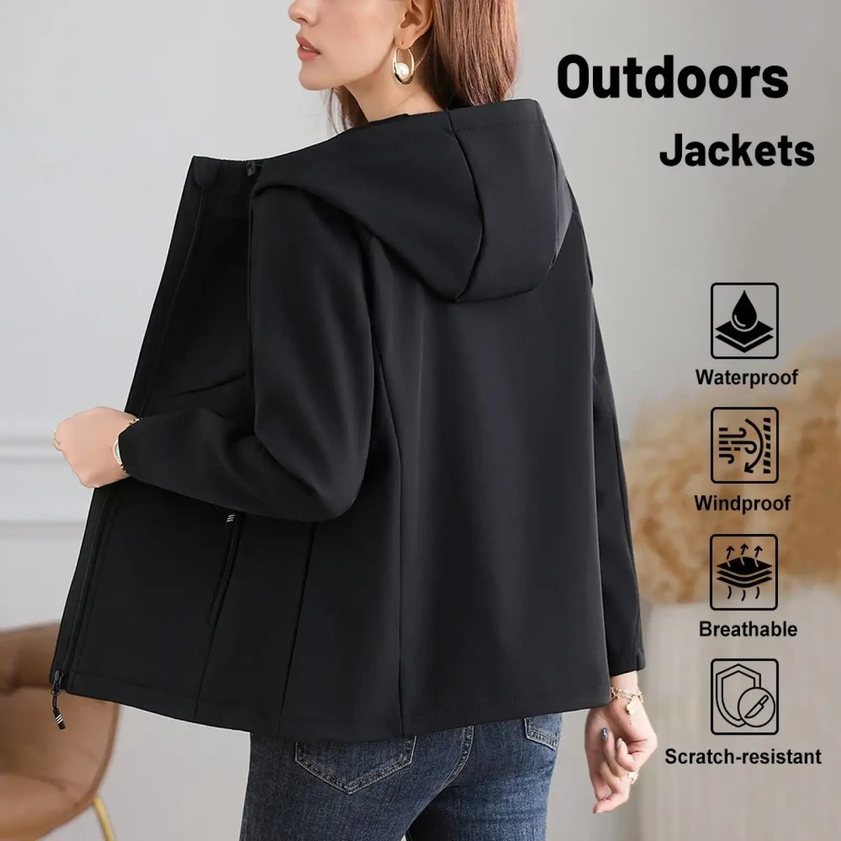 Black waterproof fleece hiking jacket for women with hood and zippered pockets designed for outdoor use