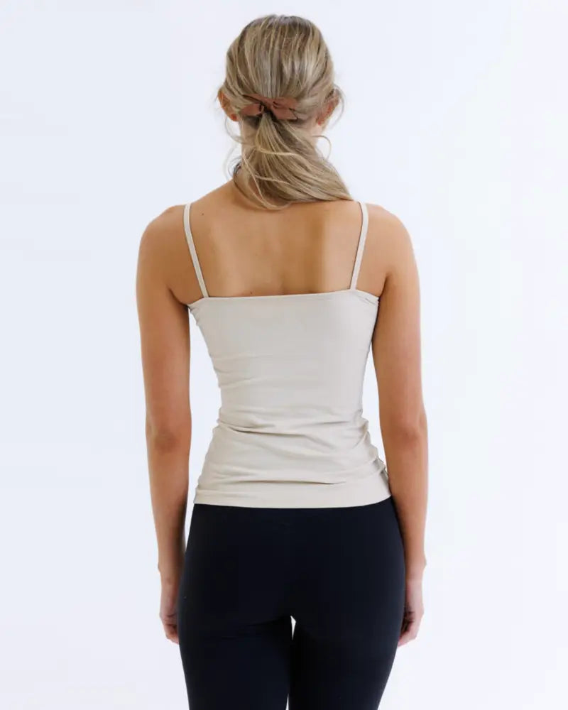 Beige cotton stretch wonder cami layering tank top shown from the back with spaghetti straps and ruched detailing