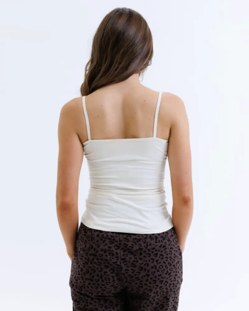 White wonder cami cotton stretch layering tank top with fitted ruched bodice and clean hemline in spaghetti strap style