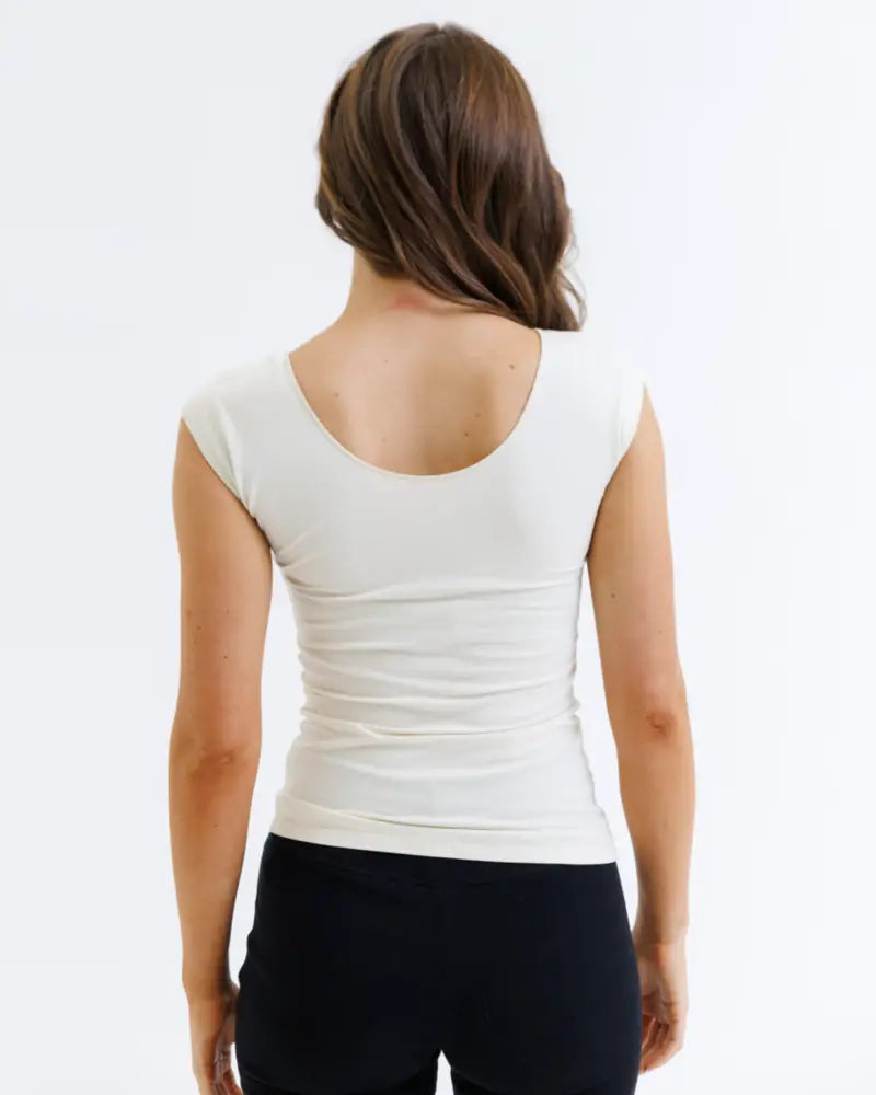 White cotton Wonder Tee scoop neck cap sleeve t-shirt shown from the back with subtle ruching for a form-fitting look