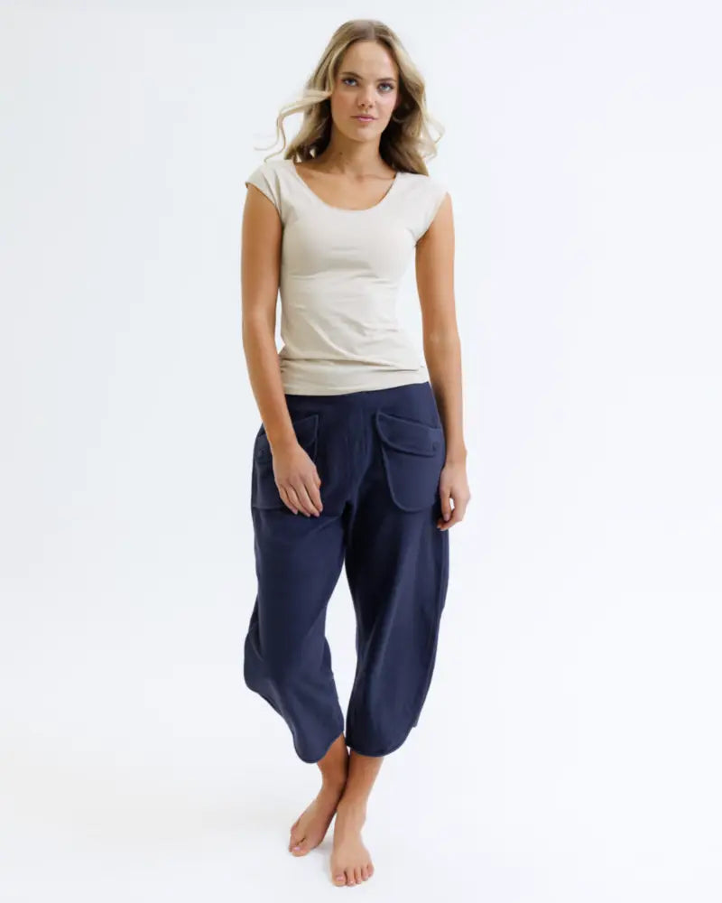 Navy blue wide-leg cropped pants with large front pockets paired with a cotton scoop neck cap sleeve t-shirt