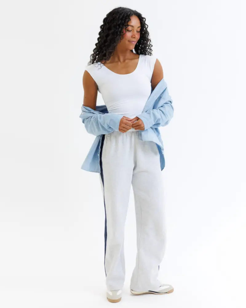 White cotton track pants with navy blue side stripes paired with wonder tee cotton scoop neck cap sleeve t-shirt