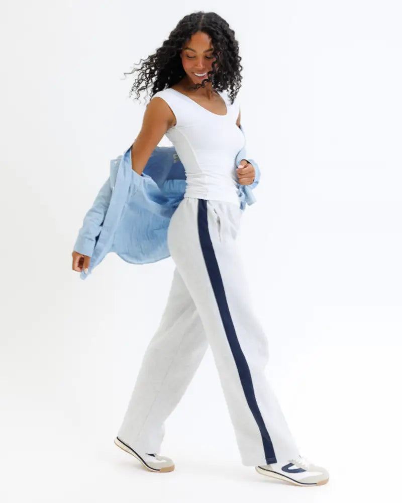 White wide-leg cotton track pants with a bold navy blue side stripe paired with wonder tee cotton scoop neck cap sleeve t-shirt