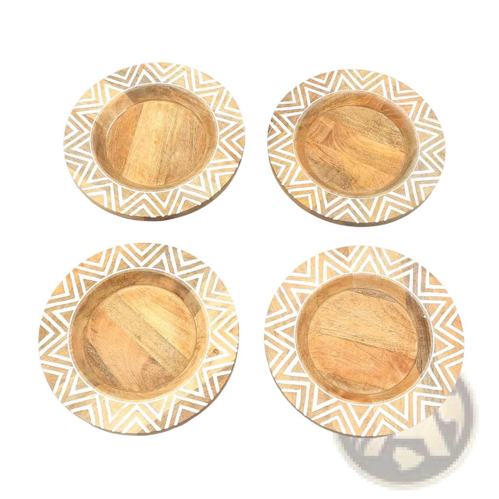 Set of four circular wooden coasters with natural wood center and white geometric zigzag inlay around the edge