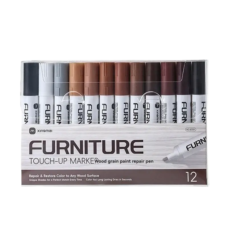 A set of twelve wood furniture repair markers in assorted wood grain colors in a clear plastic box for scratch removal