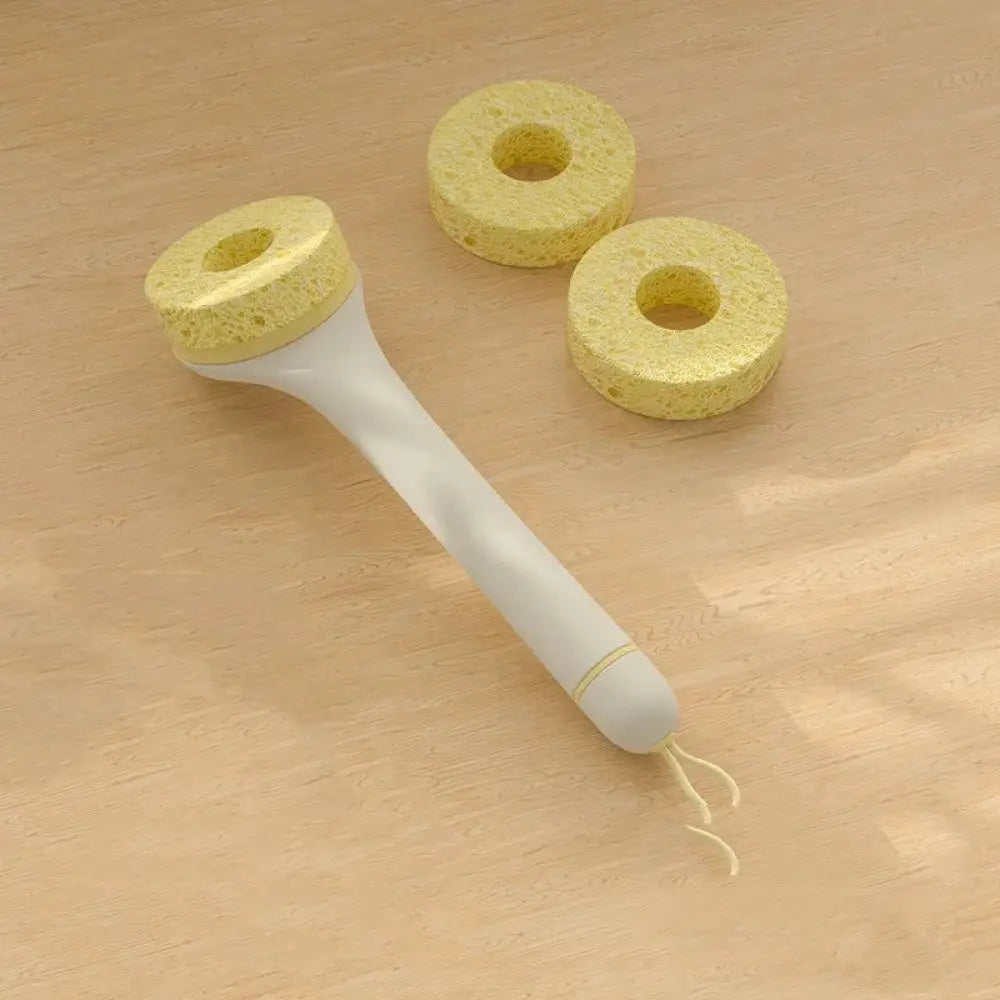 Eco friendly wood pulp kitchen scrub brush with white handle yellow porous foot scrubber head and two circular sponges nearby