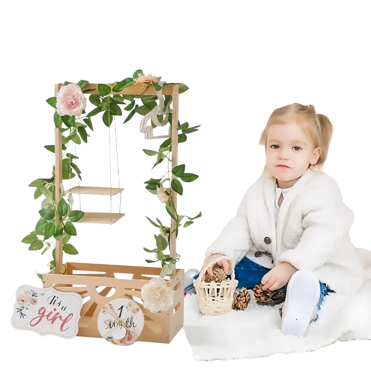 Wooden baby storage basket nursery decor with a wooden arch decorated with greenery pink flowers and a its a girl sign