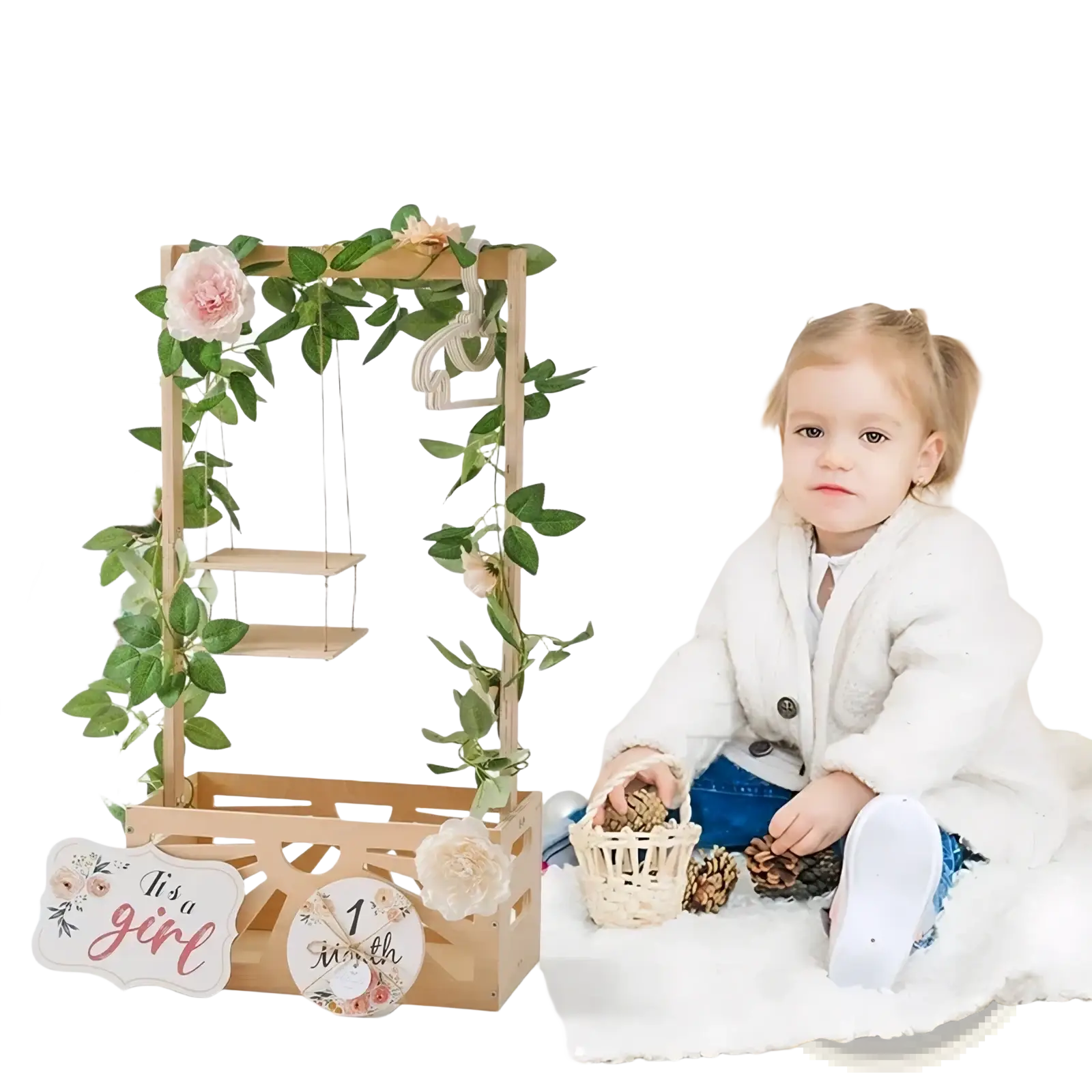 Wooden baby storage basket nursery decor with a wooden arch decorated with greenery pink flowers and a its a girl sign