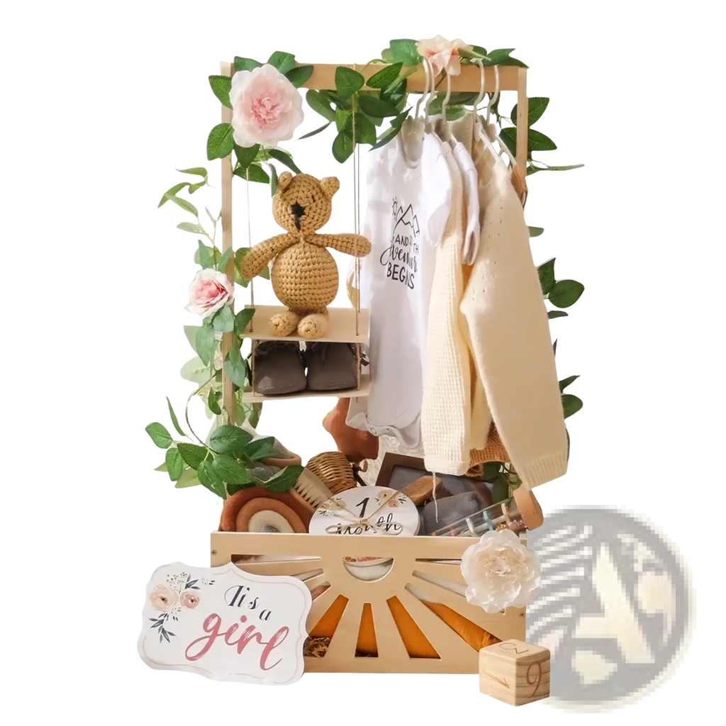 Wooden baby storage basket decorated with greenery pink flowers and a crocheted teddy bear on a swing for nursery decor