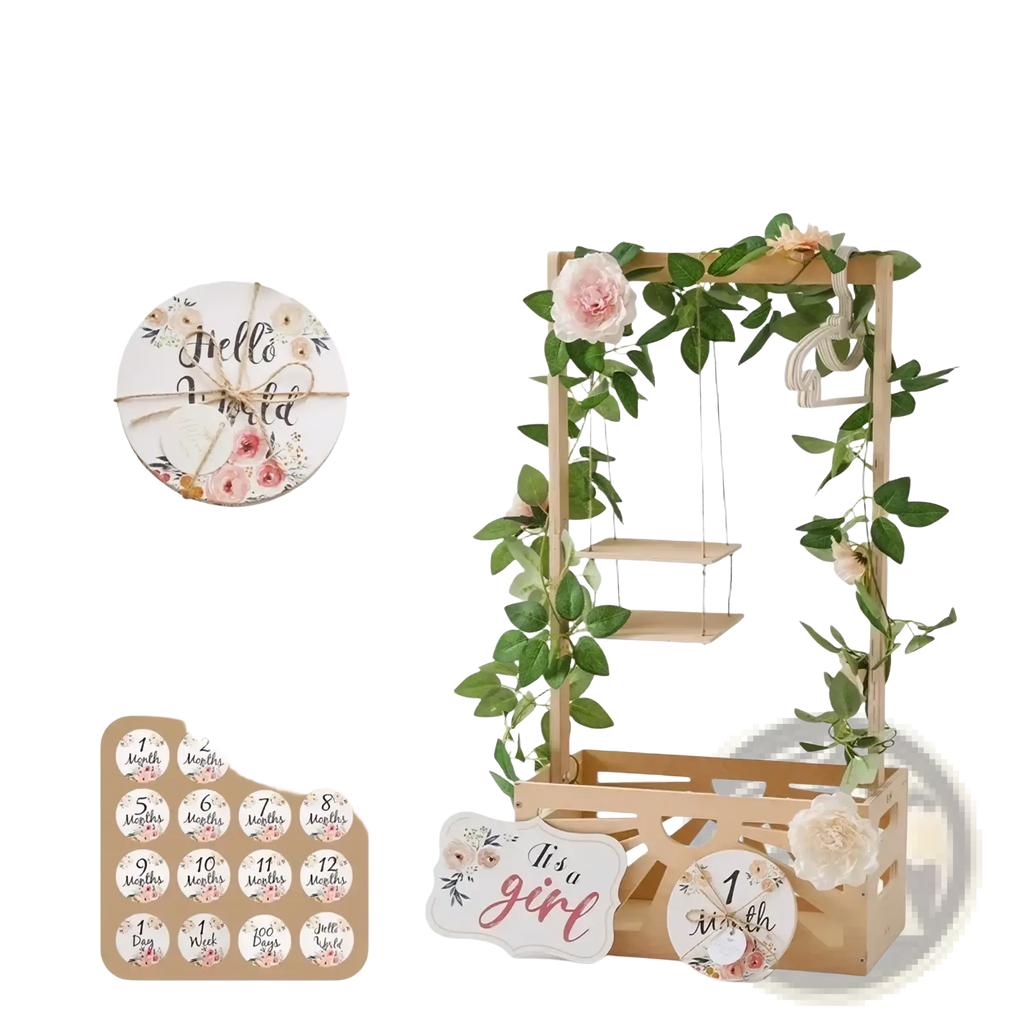 Wooden baby storage basket nursery decor with a wooden milestone stand, hanging shelf, greenery, and pink flowers