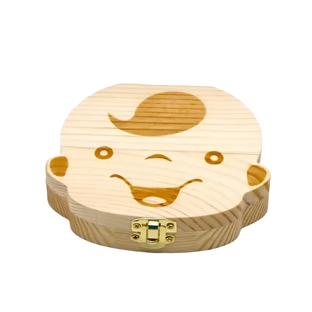 Wooden baby tooth storage box shaped like a smiling baby face with engraved details and gold metal clasp