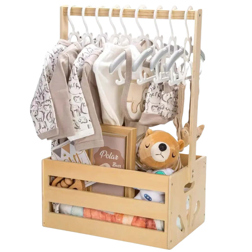 Light wood wooden baby toy storage crate and clothing organizer with white hangers holding neutral onesies and a plush bear