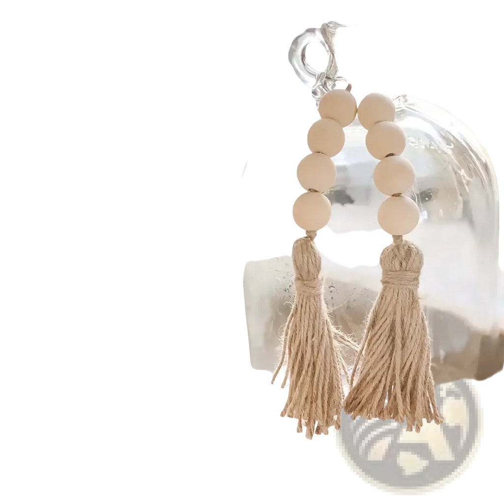 Beige wooden bead garland tassel ornament hanging from a glass jug showcasing natural wood texture