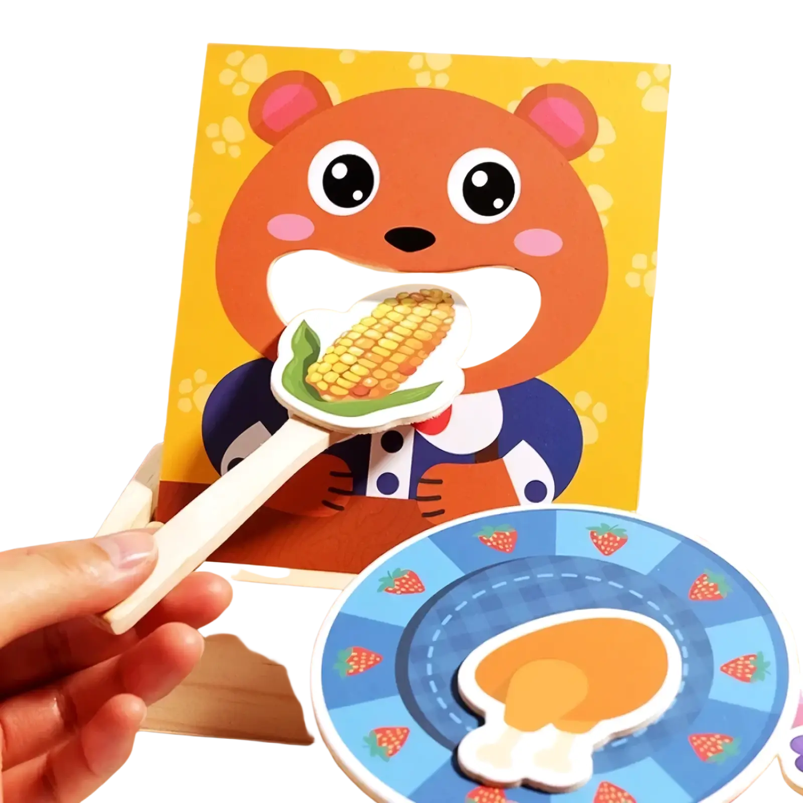 Orange wooden bear feeding game toy holding corn on the cob with pink ears and rosy cheeks in playful puzzle design