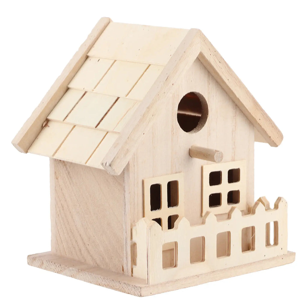 A rustic light-colored wooden bird house with shingled roof and decorative windows for parrots and small birds