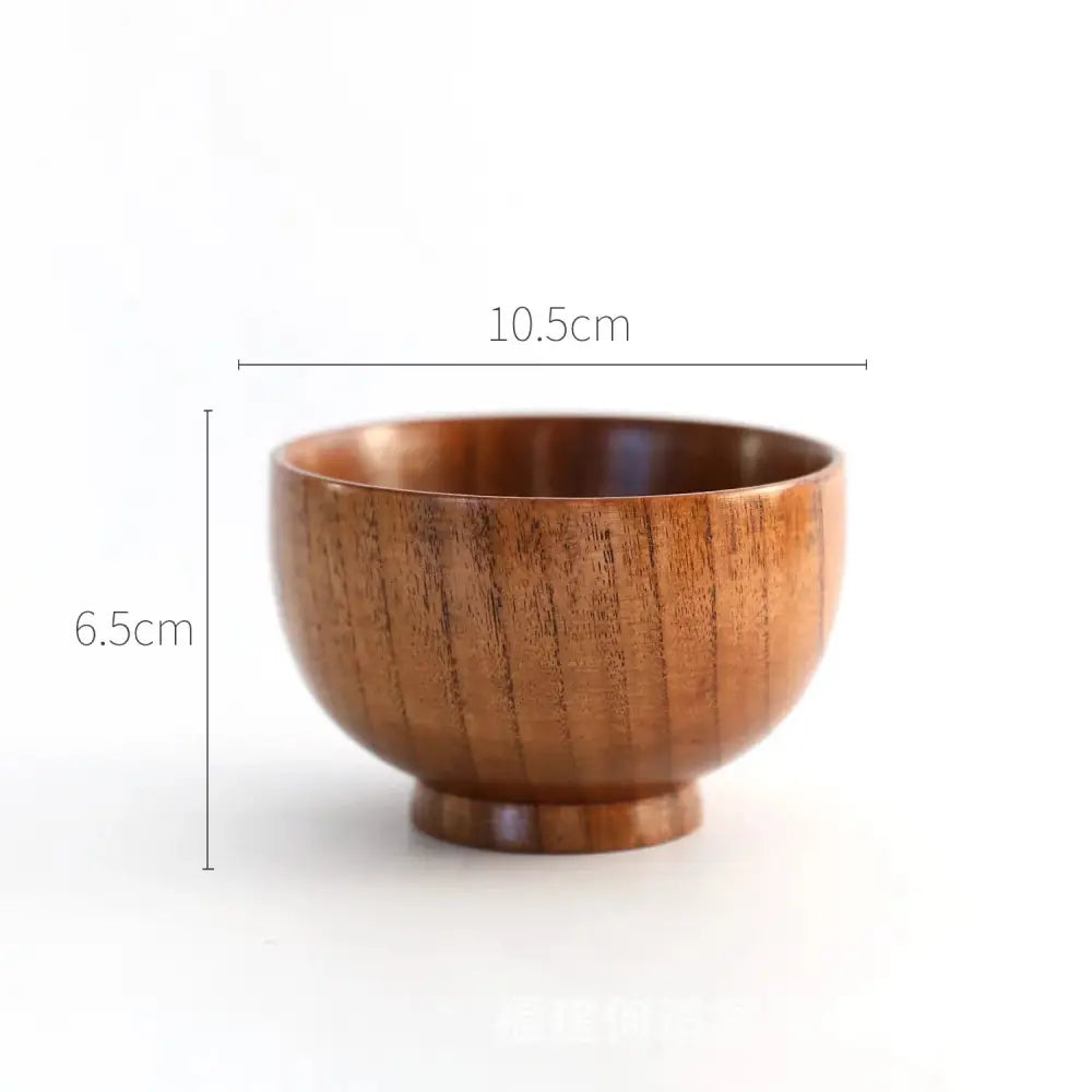 A smooth medium-brown handcrafted Japanese style natural wooden bowl with subtle grain and rounded base