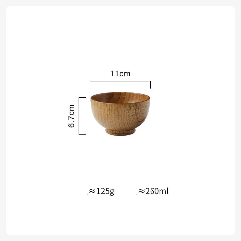 A handcrafted Japanese style natural wooden bowl in light brown with smooth natural grain finish and rounded edges