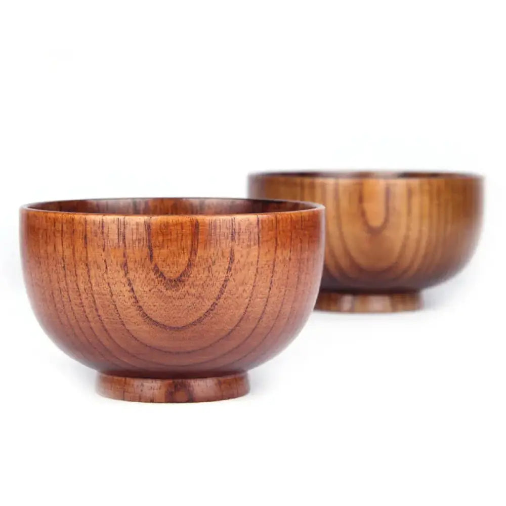 Two handcrafted Japanese style wooden bowls with a warm brown finish and natural wood grain patterns