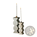 Two elegant gray wooden candle holders with textured segmented design holding lit white twisted taper candles