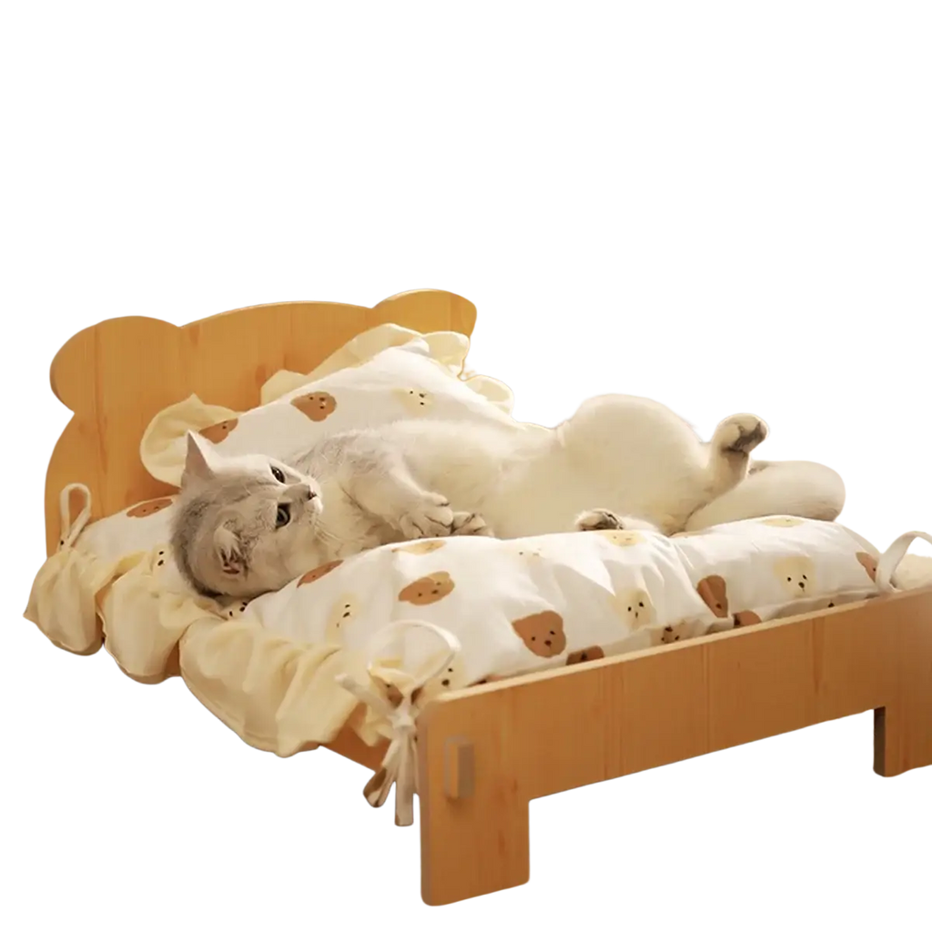 Cozy wooden cat bed with soft cream fabric cover featuring brown bear faces and ruffled edges for comfort