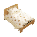 Wooden cat bed with beige teddy bear-themed bedding set featuring ruffled edges and matching pillow on wooden frame