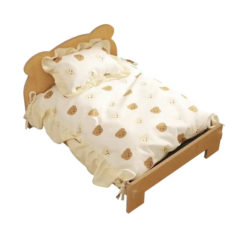Wooden cat bed with beige teddy bear-themed bedding set featuring ruffled edges and matching pillow on wooden frame