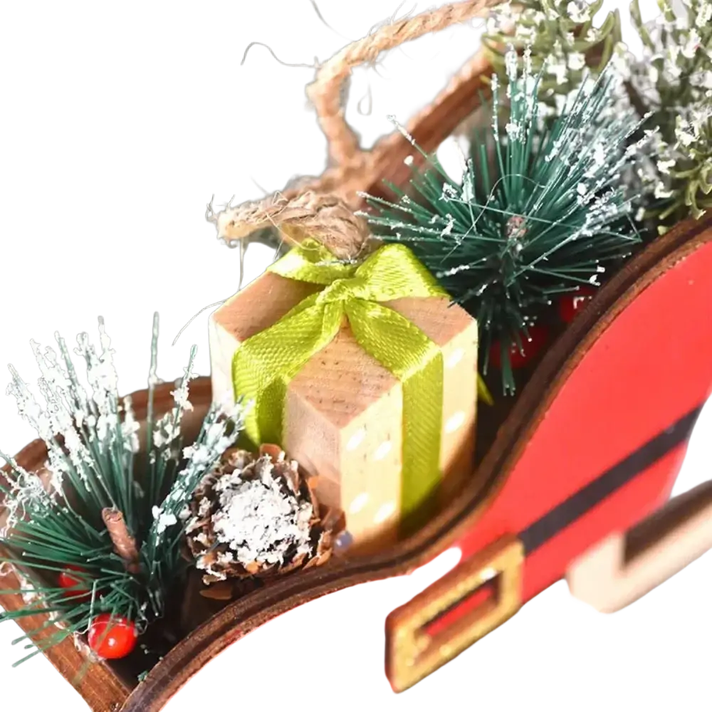 Red wooden sleigh tree hanging ornament with small gift box and snow-dusted pinecones for christmas tree decor
