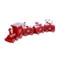 Red plastic wooden Christmas train with white snowflake decals and miniature bear figures for holiday decoration