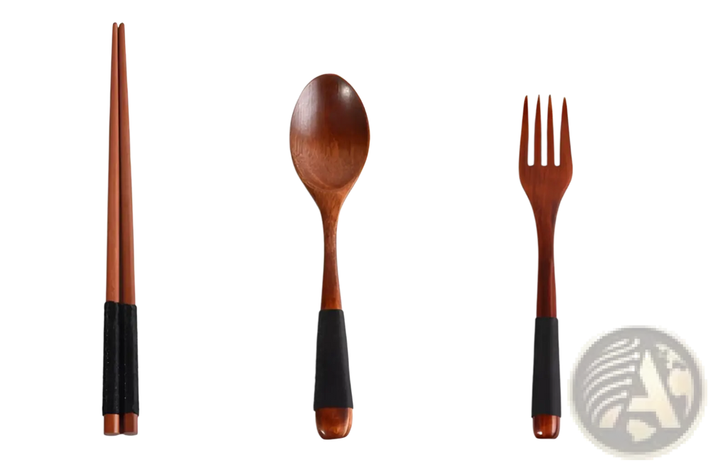 Set of four wooden reusable travel utensils with black rubberized grips in a wooden cutlery set