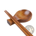 Wooden dipping sauce dish with chopstick rest in smooth medium brown wood featuring rounded bowl and rectangular base