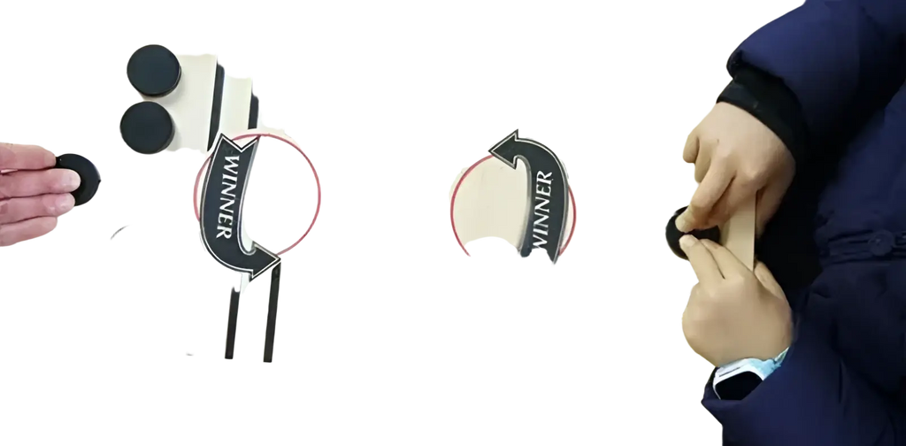 Wooden fast sling puck game with light-colored wooden tabletop and black circular discs featuring winner arrows