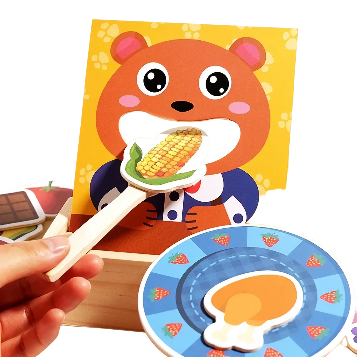 Orange bear-shaped wooden feeding toy puzzle piece with corn design pink inner ears and rosy cheeks for montessori toddlers