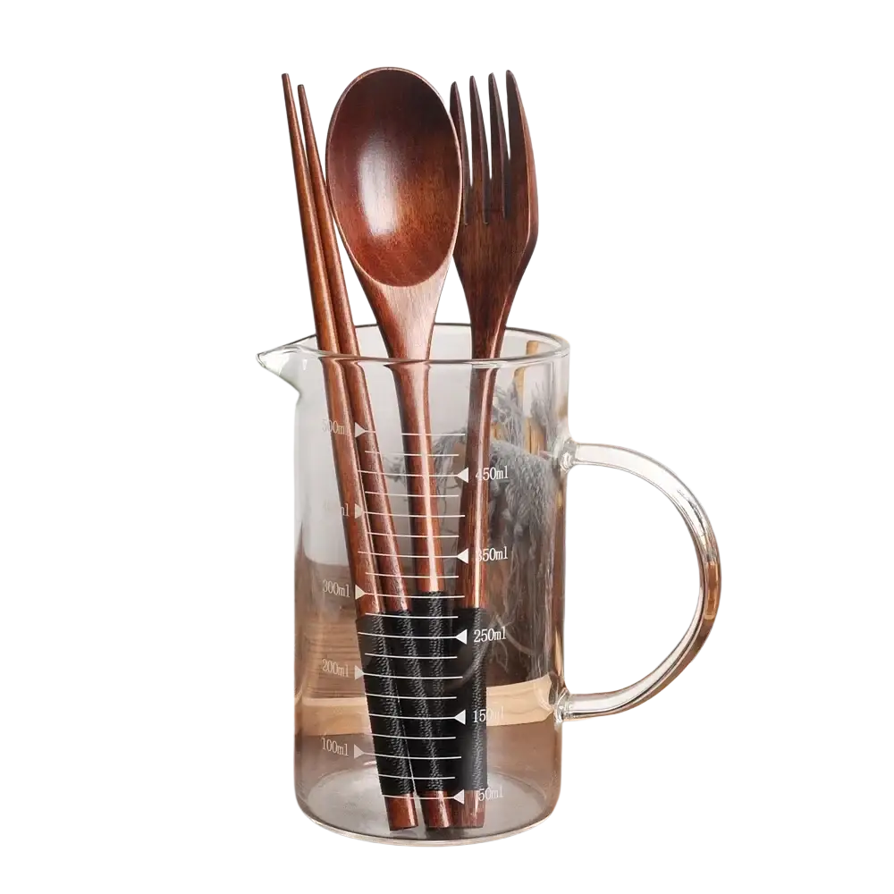 Set of brown wooden utensils in a clear glass measuring jug portable eco-friendly flatware cutlery set