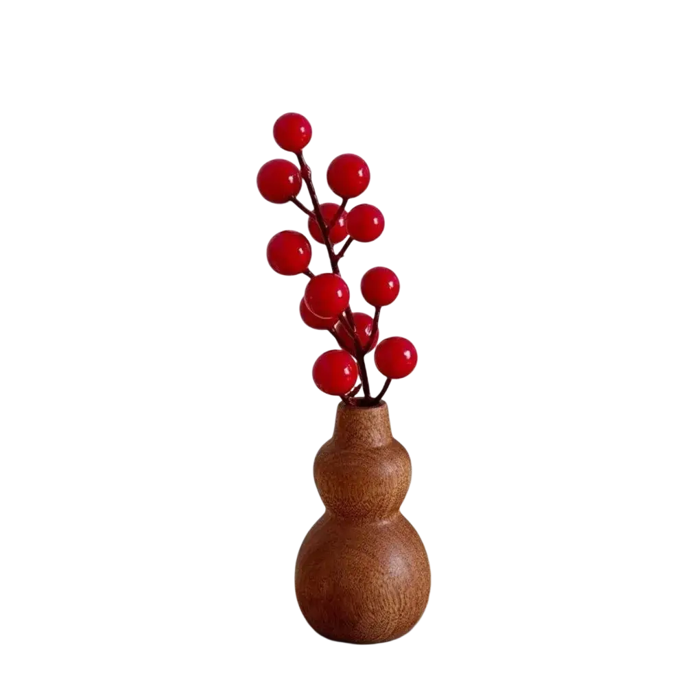 A rustic brown wooden gourd vase with glossy red spherical ornaments for minimalist tabletop decor