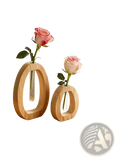 Two minimalist wooden glass bud vases with clear tubes each holding a single pink rose for desk decor
