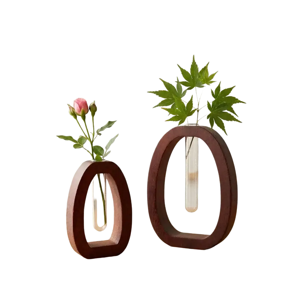 Two minimalist wooden oval vases with clear glass test tubes holding greenery and a pink rosebud for desktop use