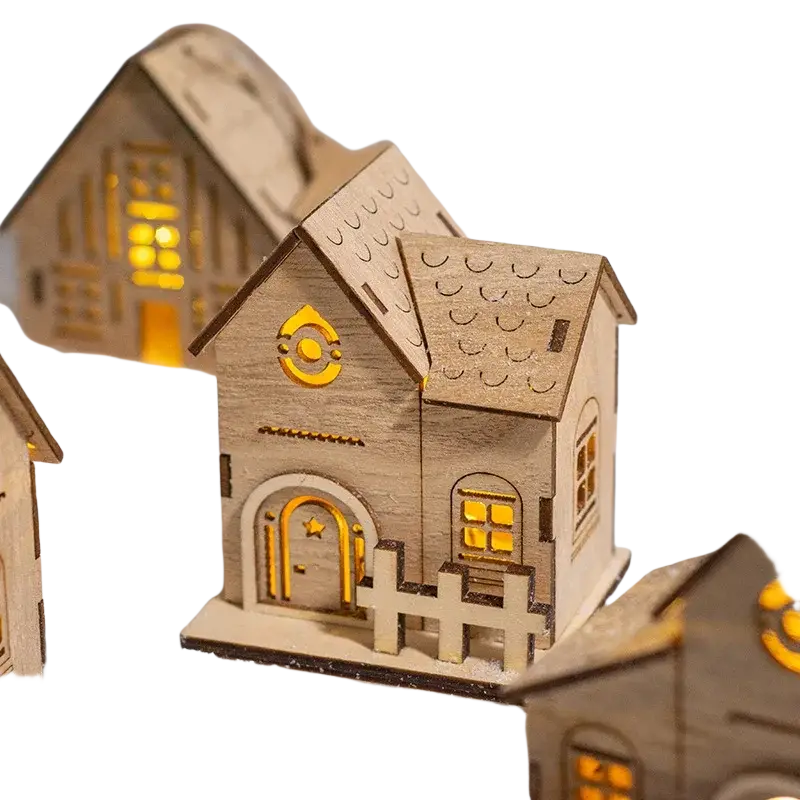 A charming wooden LED Christmas village house ornament with natural finish and glowing yellow windows and doorways