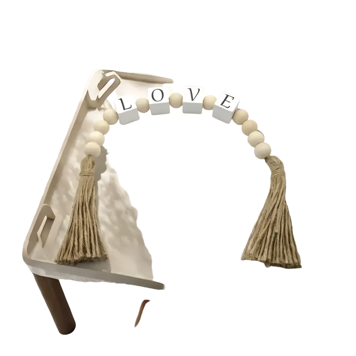 Wooden letter bead garland in beige with tassels and white letter blocks spelling love for home decor