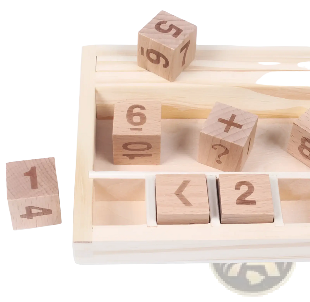 Light-colored wooden number and addition symbol blocks arranged in a matching wooden tray for math learning