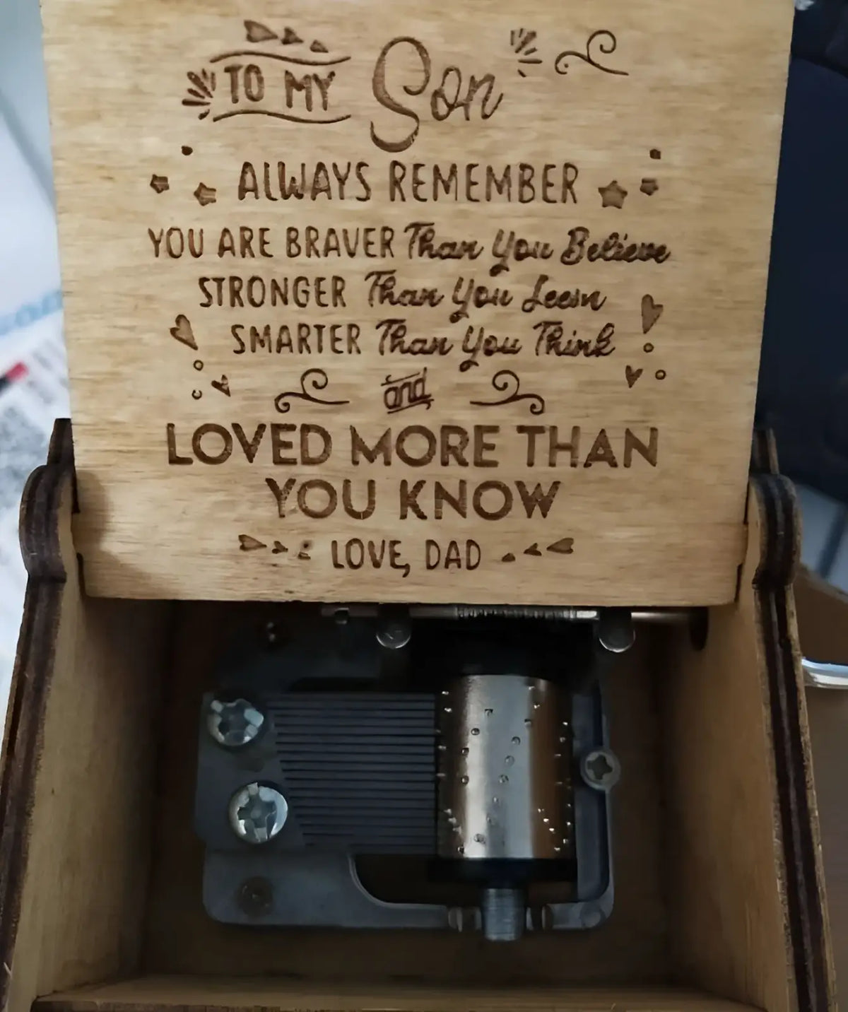 Wooden music box with hand crank featuring a laser-engraved message on the lid and an internal mechanical mechanism
